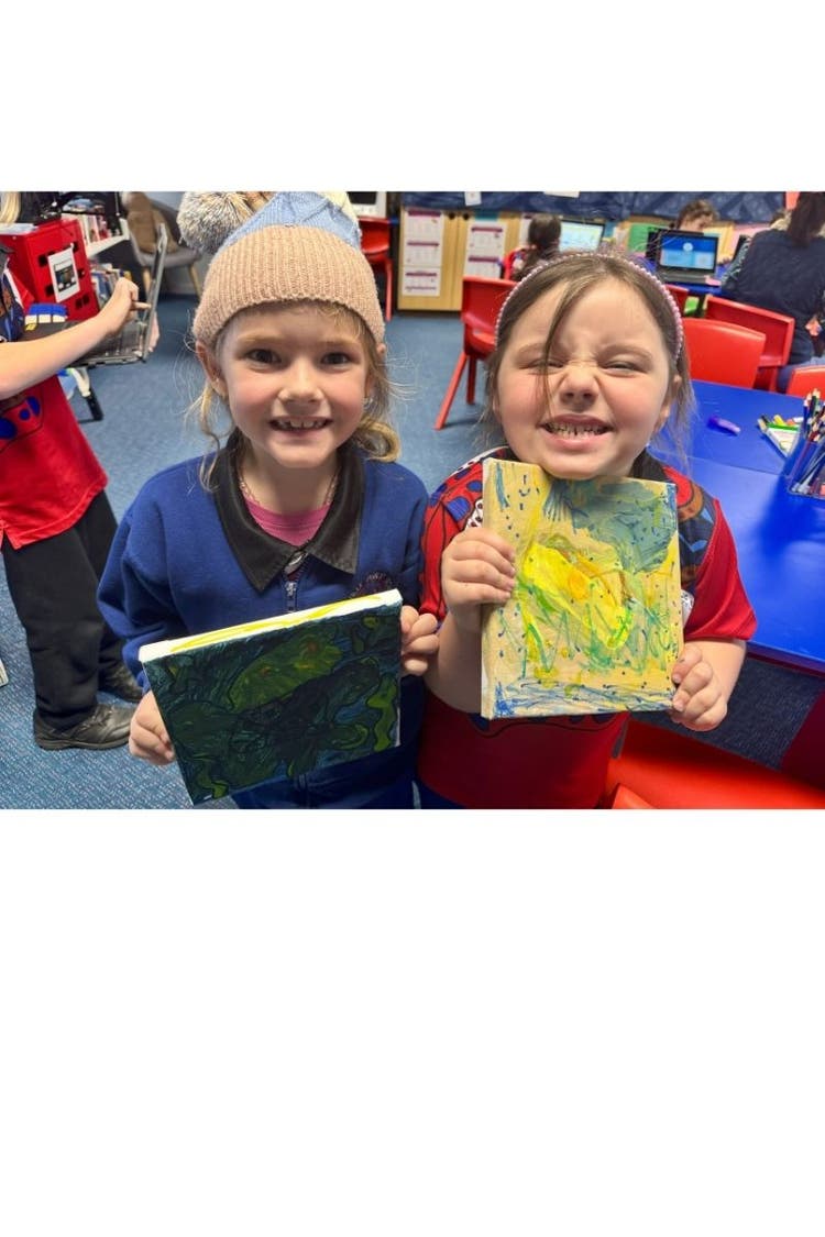 Students showing off their artwork